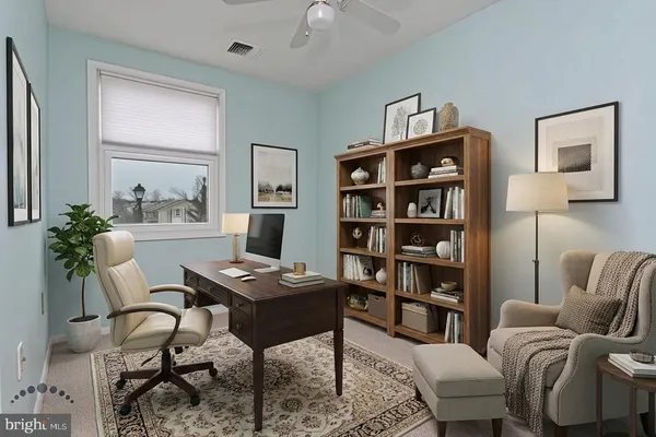 a living room with furniture and a book shelf