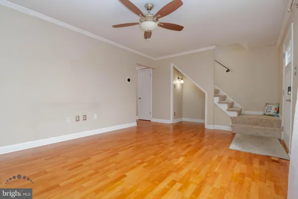 a living room with furniture a rug and a window