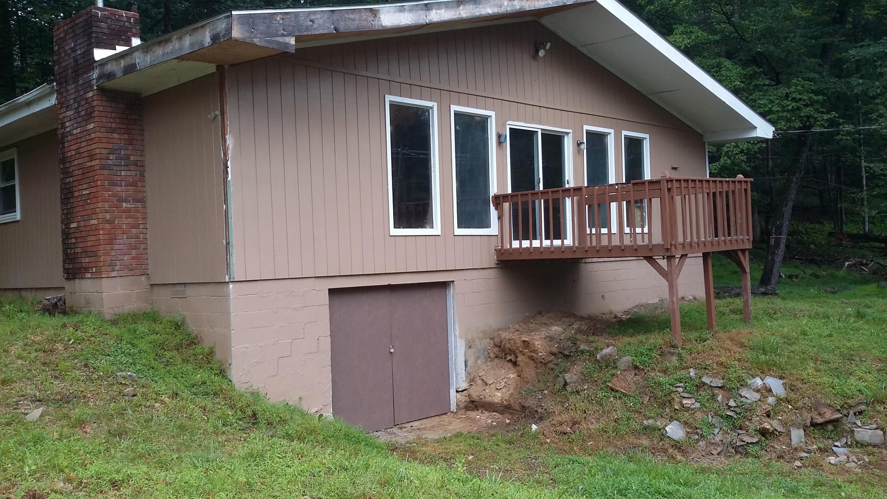 2173 Milford Road Bushkill, PA 18324 - Photo 1 of 17 a view of a house with backyard and porch