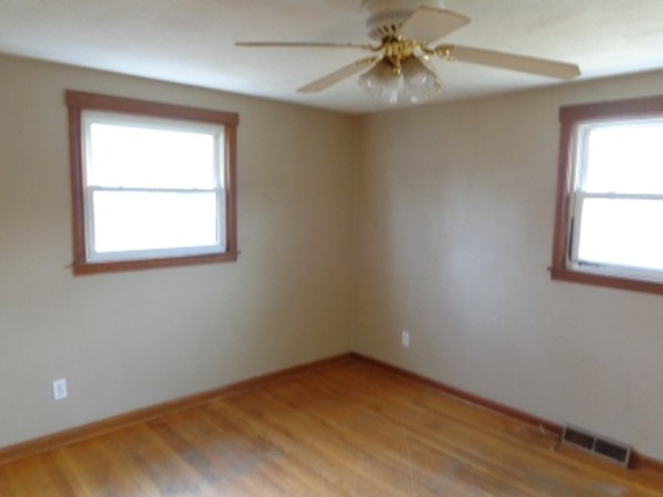 34 Mark Street Springfield, MA 01129 - Photo 7 of 15 an empty room with a window and a fan