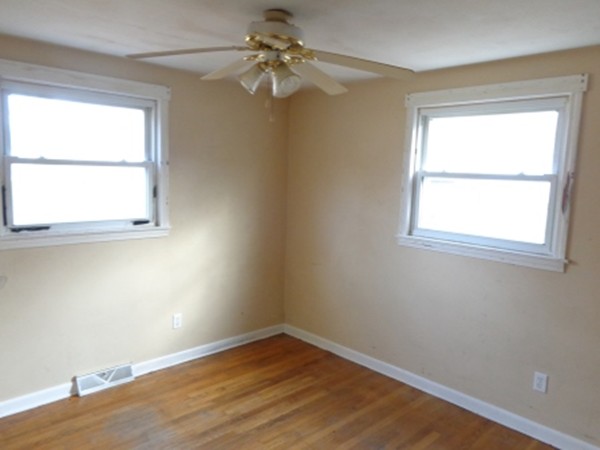 34 Mark Street Springfield, MA 01129 - Photo 8 of 15 an empty room with a window and a fan