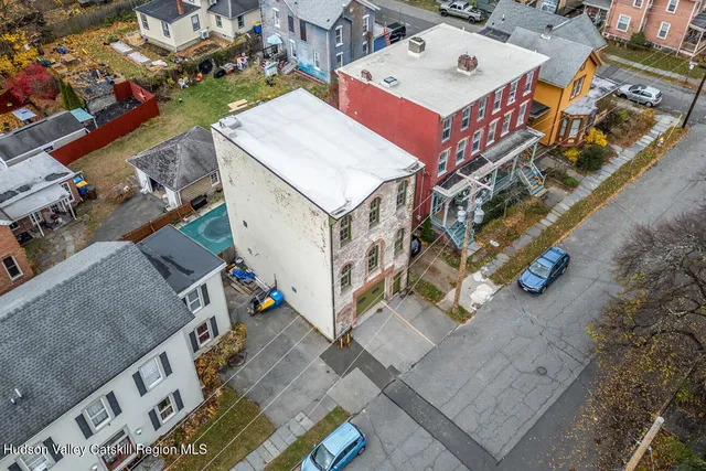 an aerial view of a house with a yard