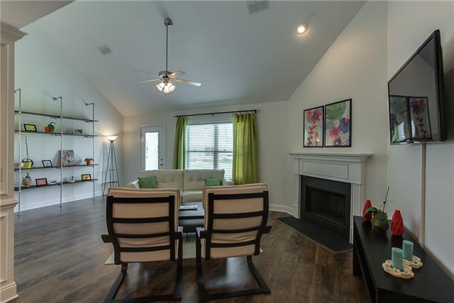 4005 Fox Run North Spring Hill, TN 37174 - Photo 5 of 20 This comfortable living room has a cozy fireplace, vaulted ceilings and looks out over the patio and backyard.
