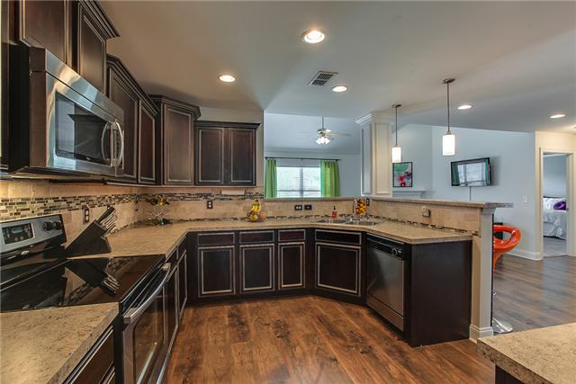 4005 Fox Run North Spring Hill, TN 37174 - Photo 6 of 20 Where to begin? Spacious open kitchen with TONS of counter space, plenty of storage cabinets, stainless steel appliances, custom tile backsplash and large pantry! Wow!