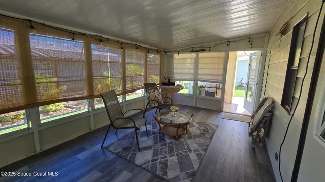 a living room with furniture and large windows
