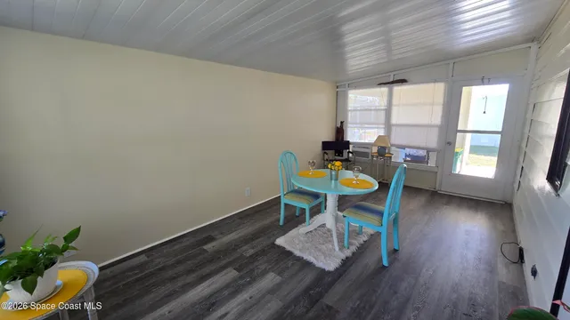 a view of a workspace with furniture and wooden floor