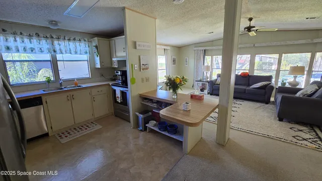 a living room with furniture a window and wooden floor