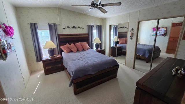 a bedroom with a bed furniture and a mirror