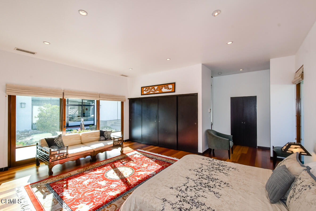 2174 Midlothian Drive Altadena, CA 91001 - Photo 39 of 54 a bedroom with a bed and glass windows