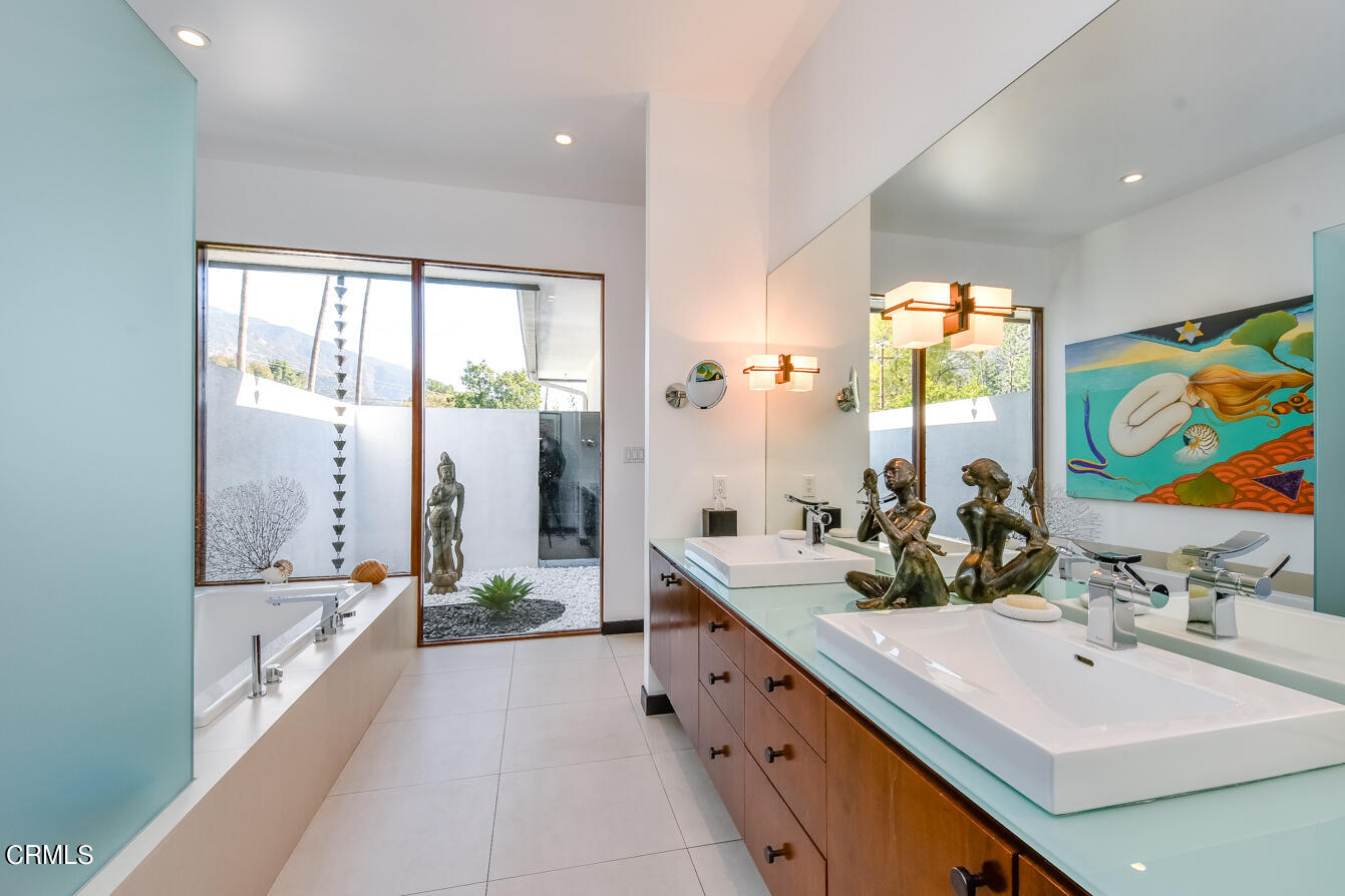 2174 Midlothian Drive Altadena, CA 91001 - Photo 41 of 54 a bathroom with a double vanity sink large mirror and a bathtub