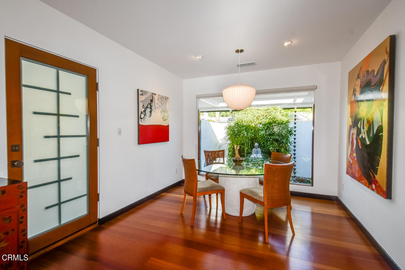 2174 Midlothian Drive Altadena, CA 91001 - Photo 10 of 54 a dining room with wooden floor a flat screen tv and a rug