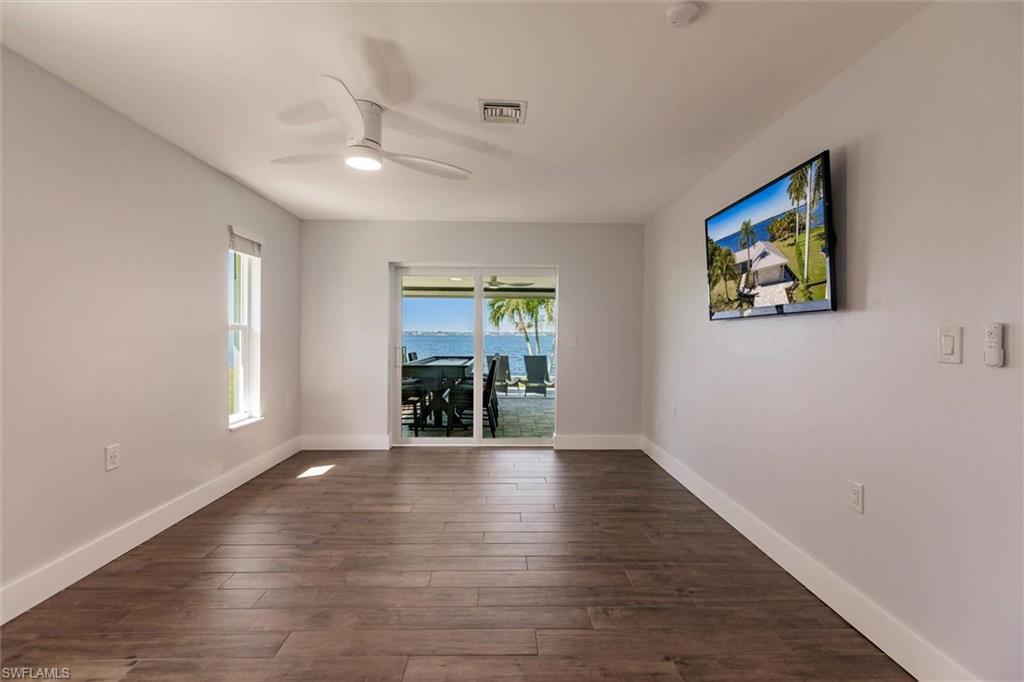 138 Riverview Road Fort Myers, FL 33905 - Photo 26 of 50 Empty room featuring dark wood-style floors, visible vents, ceiling fan, and baseboards