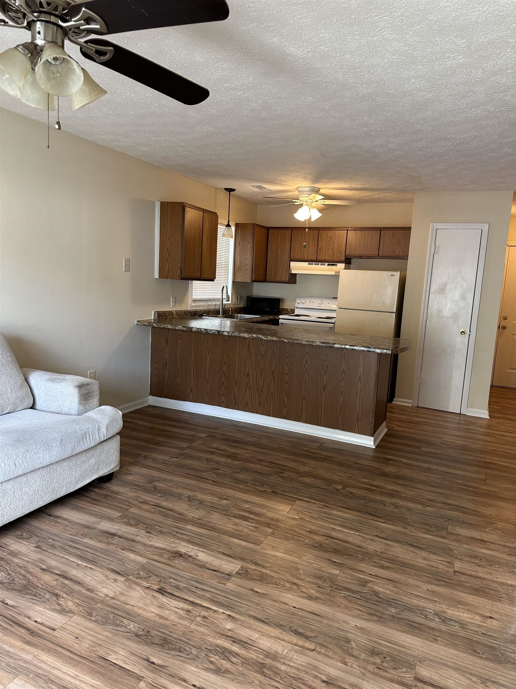 420 Pine Avenue Murrells Inlet, SC 29576 - Photo 21 of 21 Kitchen with open floor plan, a ceiling fan, dark countertops, a peninsula, and white appliances