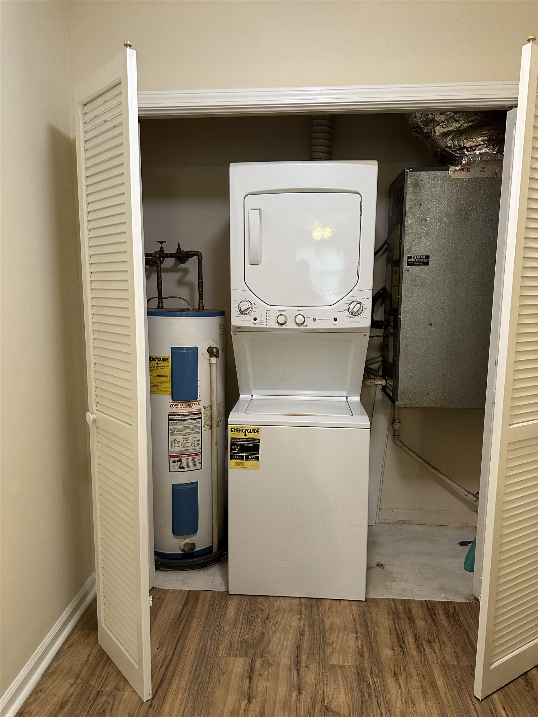 420 Pine Avenue Murrells Inlet, SC 29576 - Photo 15 of 21 Washroom with water heater, estacked washer and dryer, light wood-style flooring, and electric panel