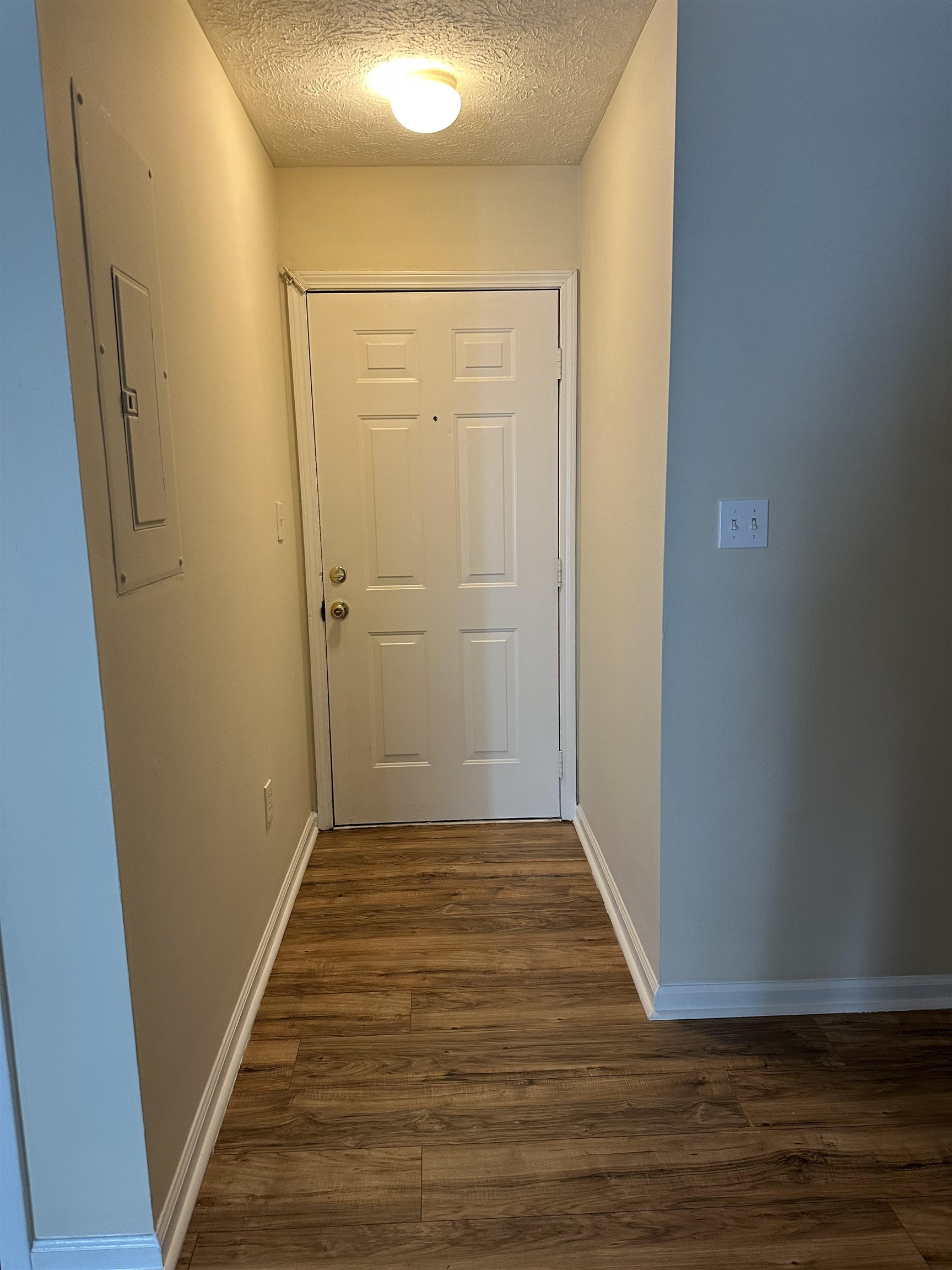 420 Pine Avenue Murrells Inlet, SC 29576 - Photo 7 of 21 Doorway to outside with wood finished floors, electric panel, and a textured ceiling