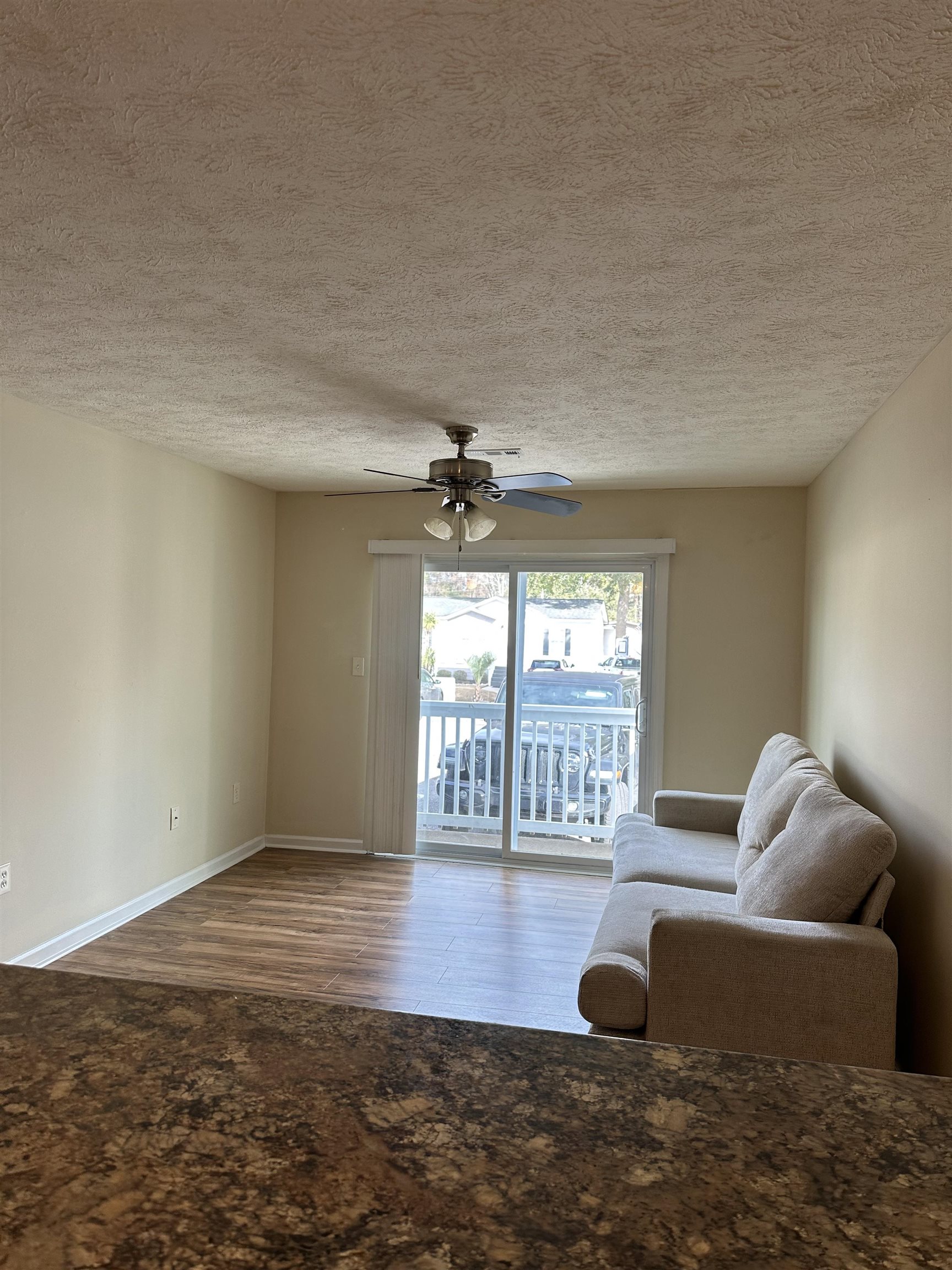 420 Pine Avenue Murrells Inlet, SC 29576 - Photo 8 of 21 Living room with a textured ceiling, wood finished floors, and ceiling fan