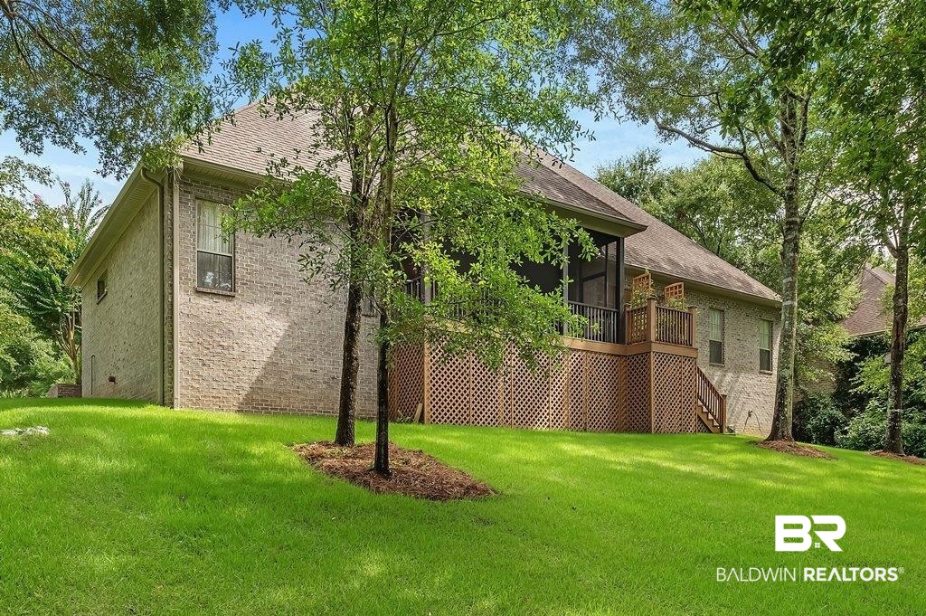 29976 Dolive Ridge Daphne, AL 36527 - Photo 5 of 58 View of home's exterior with a yard and a sunroom