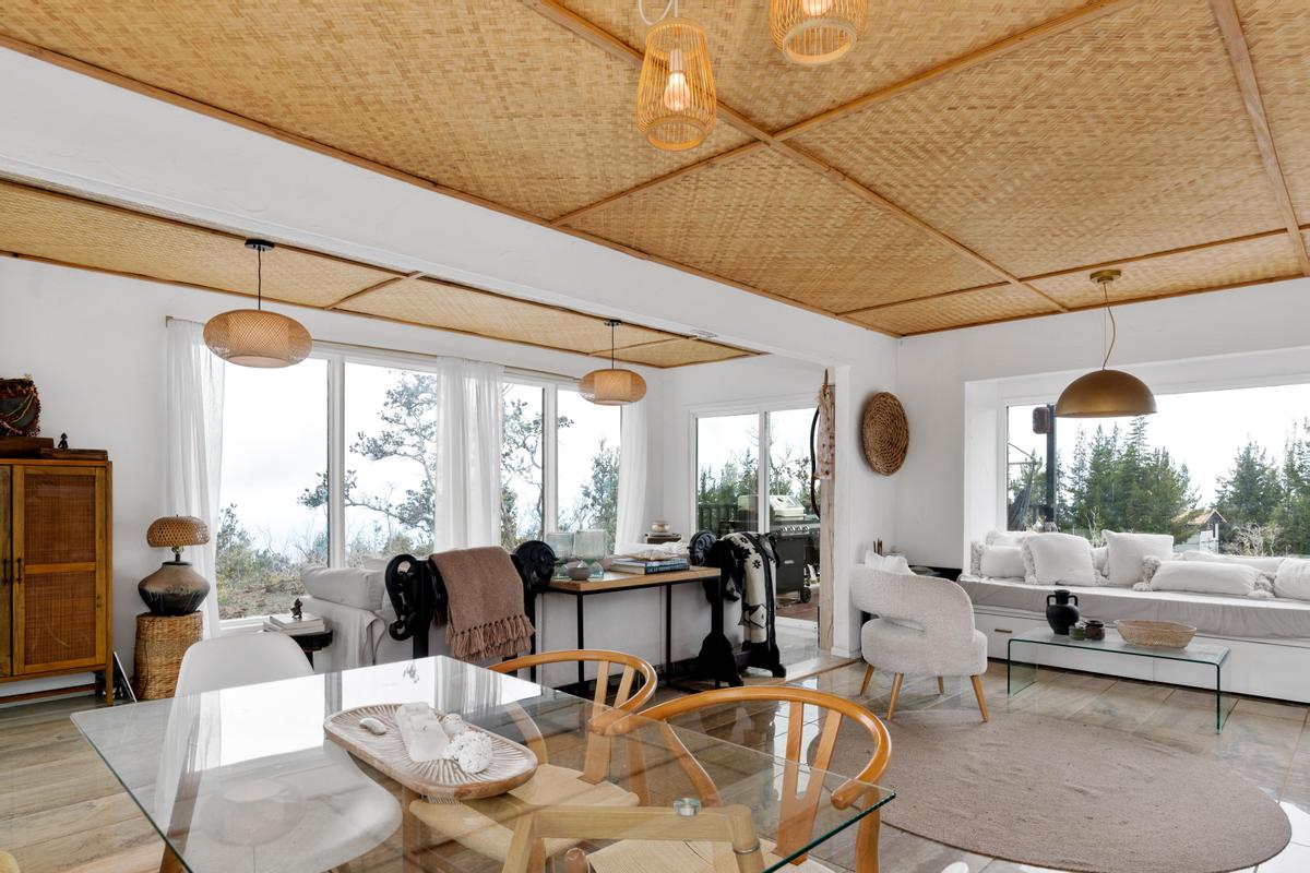 a living room with fireplace furniture and a large window