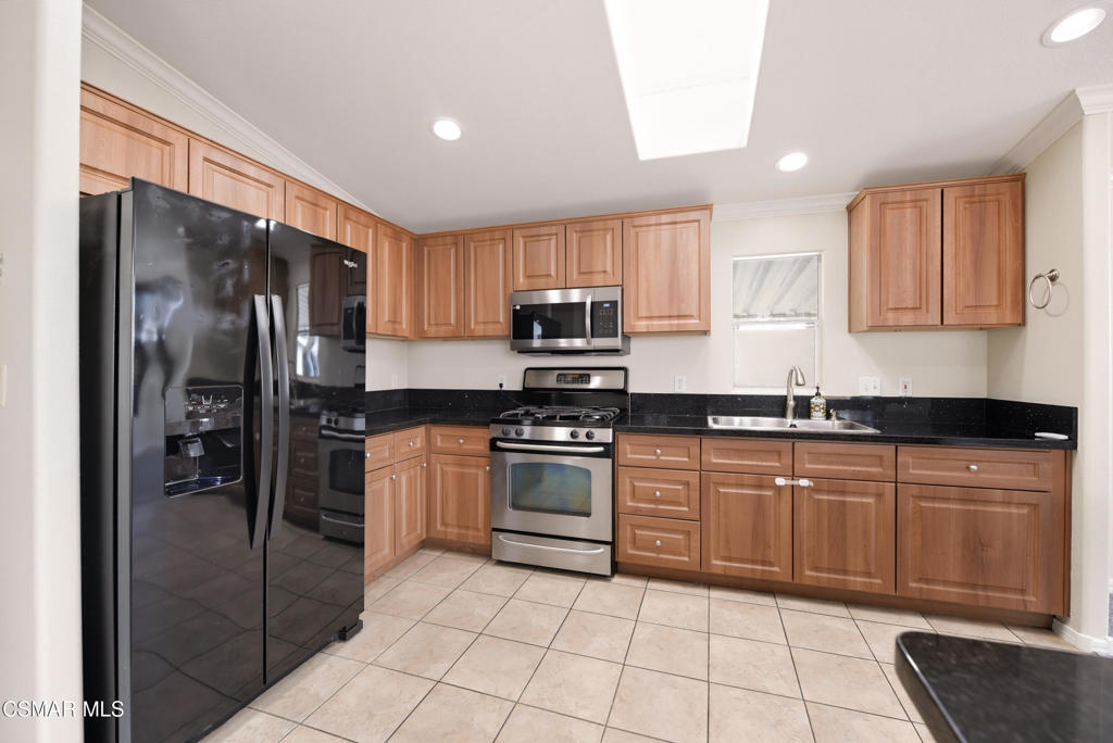 89 Via Gabilan Camarillo, CA 93012 - Photo 13 of 34 a kitchen with stainless steel appliances granite countertop a refrigerator and a stove top oven