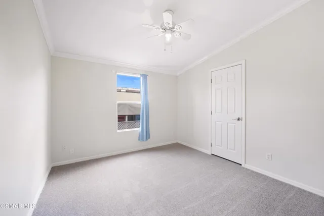a view of a livingroom with a ceiling fan and window