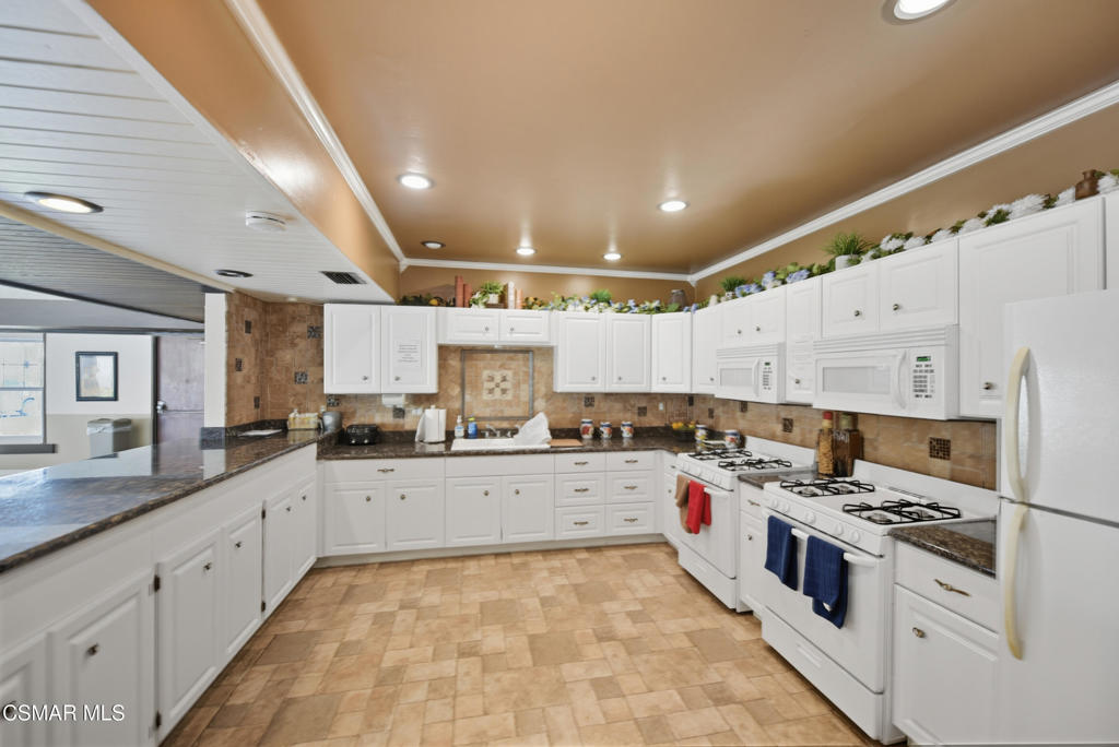 89 Via Gabilan Camarillo, CA 93012 - Photo 25 of 34 a large white kitchen with a stove top oven a sink and dishwasher