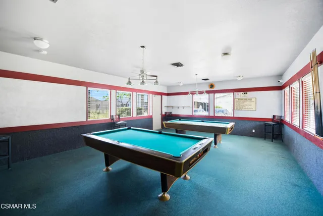 swimming pool view with a seating space