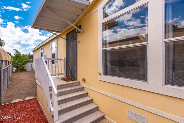 a kitchen with stainless steel appliances kitchen island granite countertop a stove a sink a refrigerator with white cabinets and a granite counter top