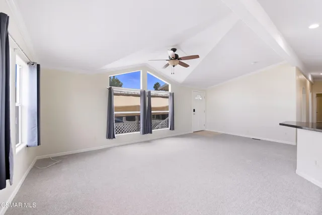 a large white kitchen with kitchen island a sink stainless steel appliances and cabinets