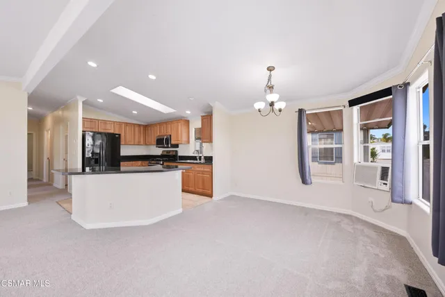 a kitchen with stainless steel appliances granite countertop a sink and a refrigerator