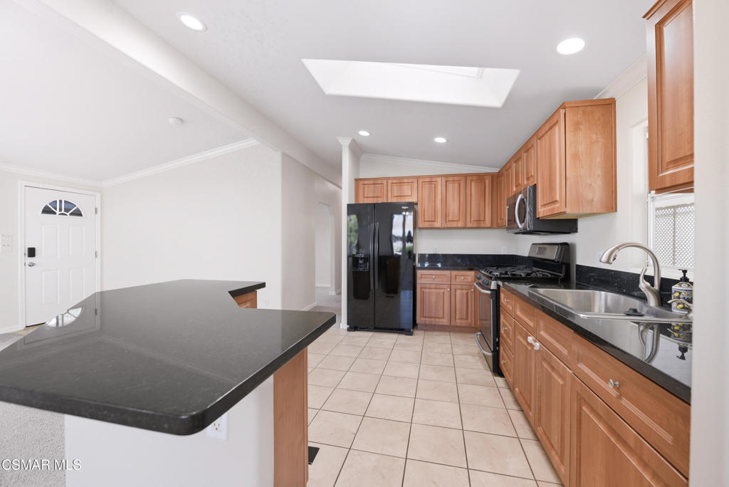 89 Via Gabilan Camarillo, CA 93012 - Photo 9 of 34 a kitchen with stainless steel appliances granite countertop a sink and a refrigerator