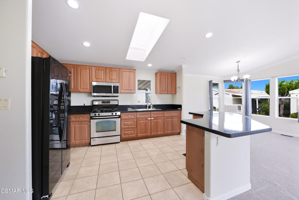 89 Via Gabilan Camarillo, CA 93012 - Photo 10 of 34 a kitchen with stainless steel appliances granite countertop a stove top oven a sink a counter top space and cabinets