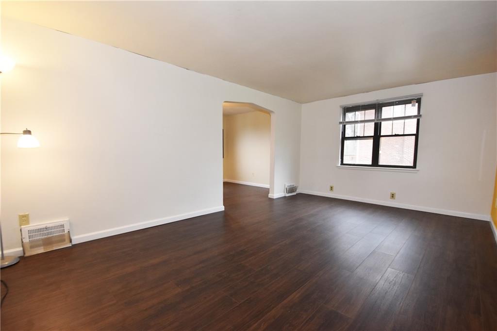721 Highview Road Pittsburgh, PA 15234 - Photo 3 of 23 an empty room with wooden floor and windows