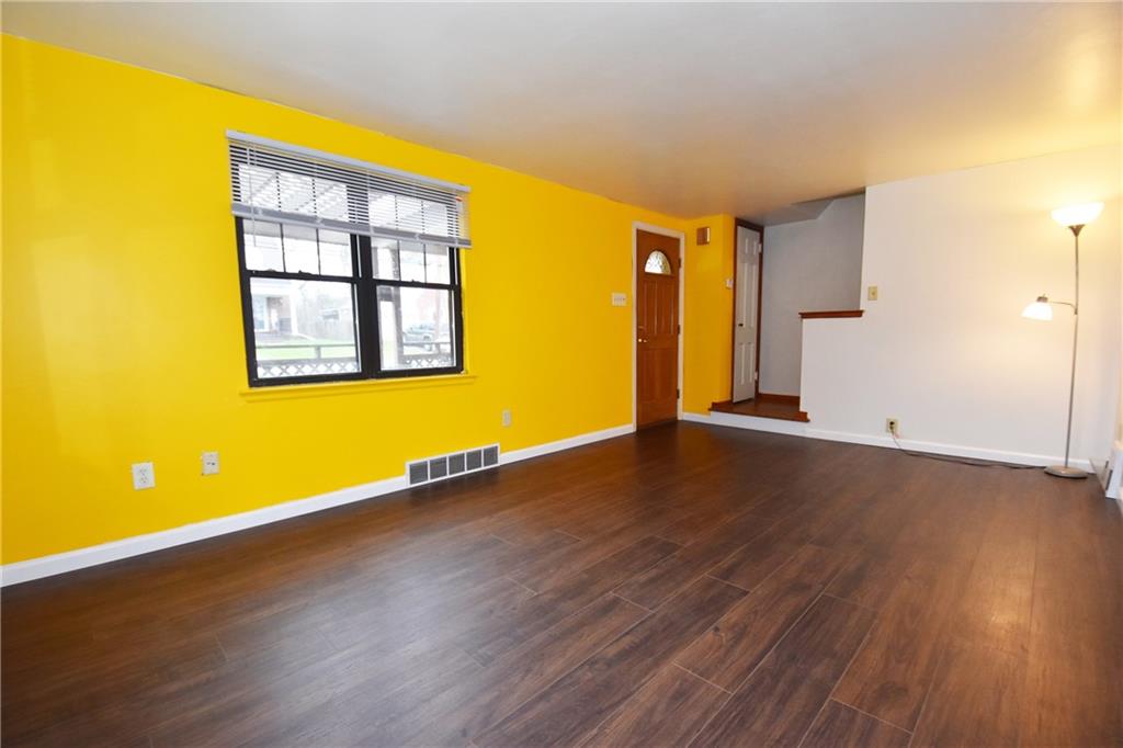 721 Highview Road Pittsburgh, PA 15234 - Photo 6 of 23 a view of an empty room with wooden floor and a window
