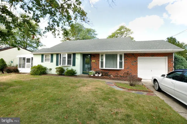 a house view with a sitting space and garden