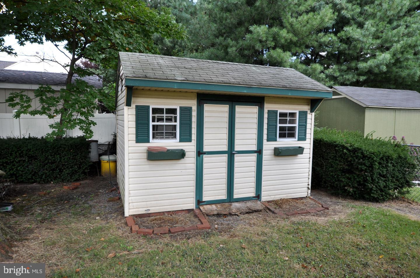 811 Fordham Street Delran, NJ 08075 - Photo 18 of 20 a view of a white house with large windows and a small yard