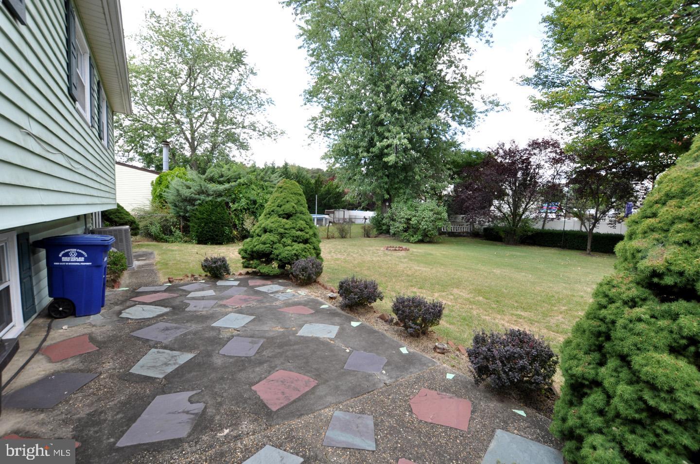811 Fordham Street Delran, NJ 08075 - Photo 19 of 20 a view of a backyard with chairs and a fire pit