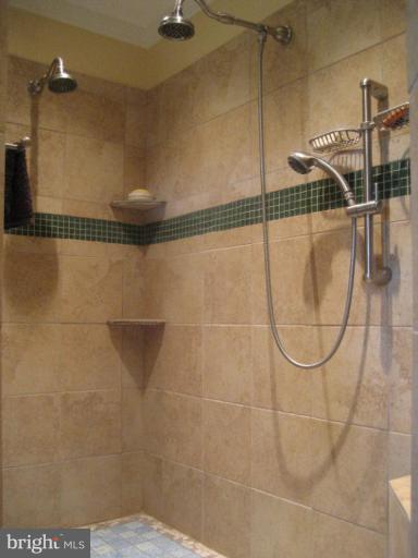 17019 West Willard Road Poolesville, MD 20837 - Photo 16 of 24 a bathroom with a glass shower door