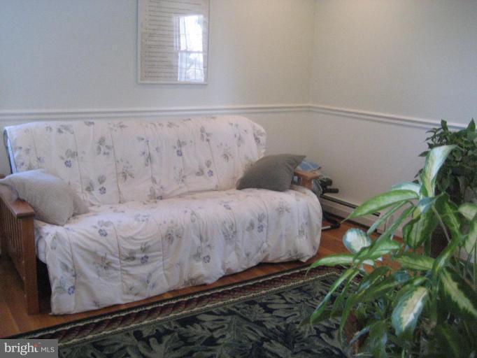 17019 West Willard Road Poolesville, MD 20837 - Photo 18 of 24 a bed sitting in a bedroom next to a window