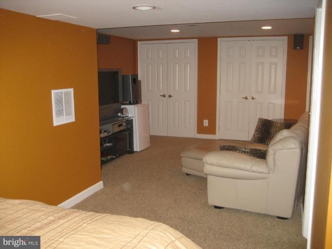 17019 West Willard Road Poolesville, MD 20837 - Photo 20 of 24 a bedroom with a bed and a couch