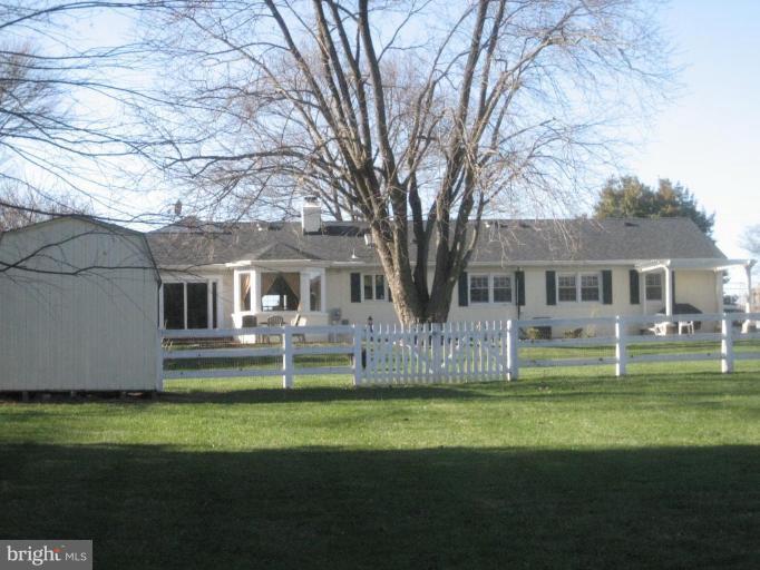17019 West Willard Road Poolesville, MD 20837 - Photo 6 of 24 a front view of house with a garden and trees