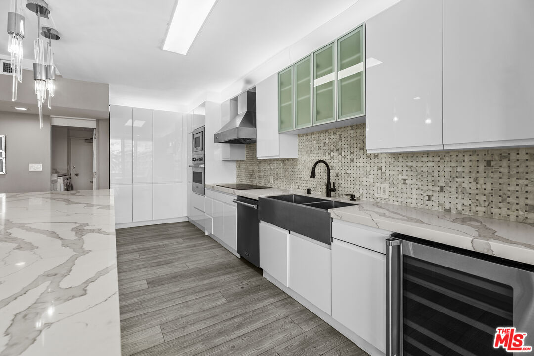 1333 South Beverly Glen Boulevard, Unit 605 Los Angeles, CA 90024 - Photo 11 of 27 a kitchen with a sink and cabinets