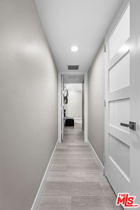 1333 South Beverly Glen Boulevard, Unit 605 Los Angeles, CA 90024 - Photo 12 of 27 a view of a hallway with wooden floor and staircase