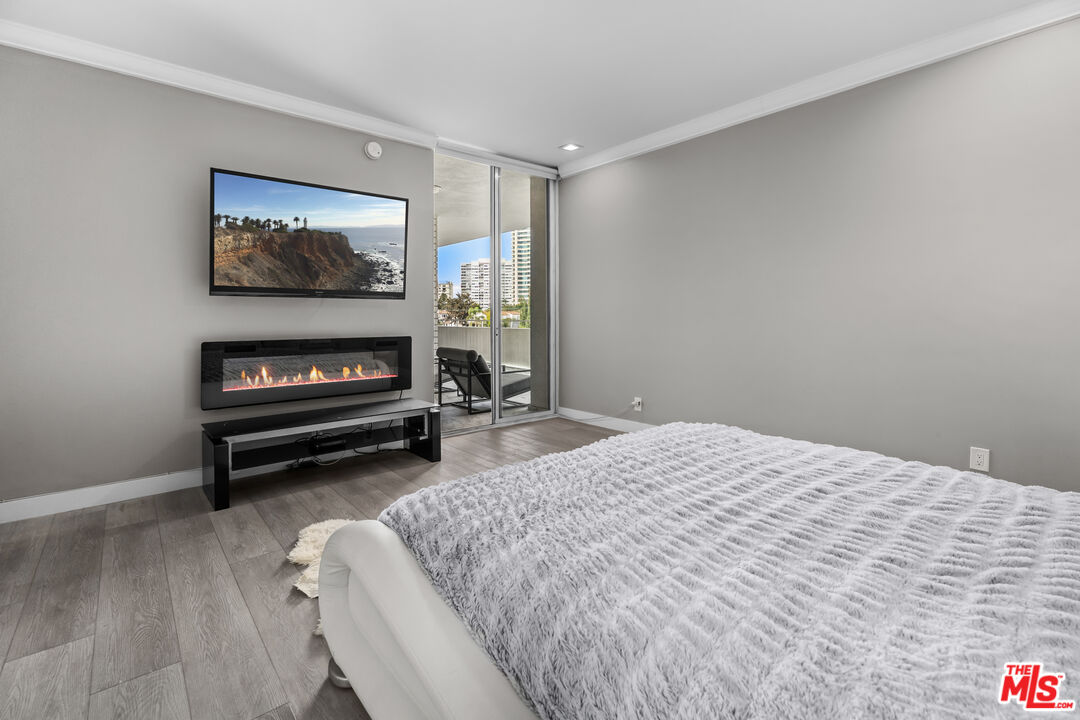 1333 South Beverly Glen Boulevard, Unit 605 Los Angeles, CA 90024 - Photo 14 of 27 a bedroom with a bed and a flat screen tv