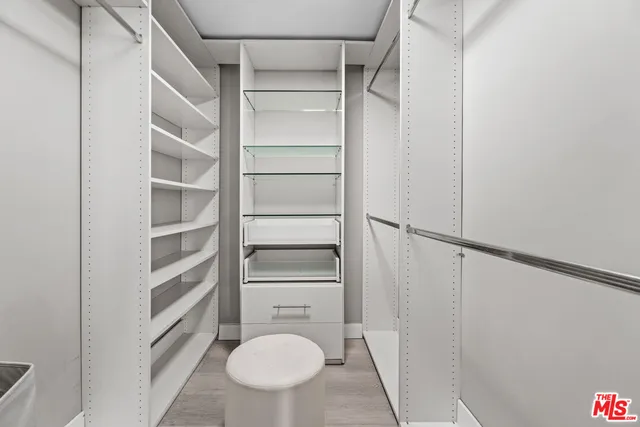 a view of walk in closet with empty racks