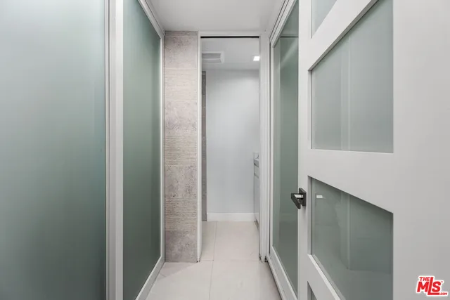 a bathroom with a shower and a glass door