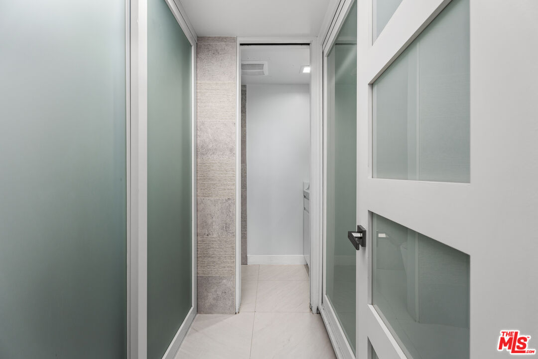 1333 South Beverly Glen Boulevard, Unit 605 Los Angeles, CA 90024 - Photo 19 of 27 a bathroom with a shower and a glass door