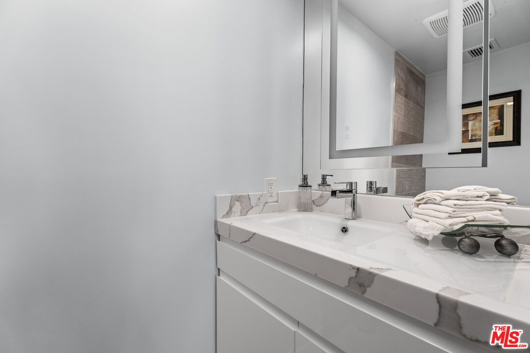 1333 South Beverly Glen Boulevard, Unit 605 Los Angeles, CA 90024 - Photo 20 of 27 a bathroom with a sink and a mirror
