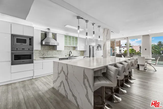 a large kitchen with lots of counter space and stainless steel appliances