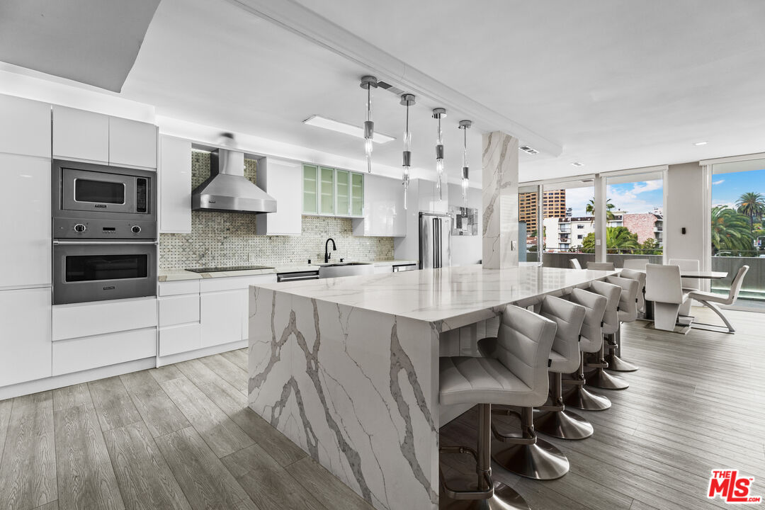 1333 South Beverly Glen Boulevard, Unit 605 Los Angeles, CA 90024 - Photo 2 of 27 a large kitchen with lots of counter space and stainless steel appliances