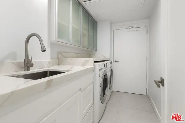 a close view of a sink a washer and dryer